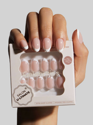 Hand holding a box of Salon U-Ltimate nail extensions with a neutral background