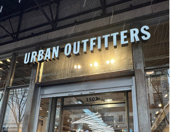 Urban Outfitters sign about glass door.
