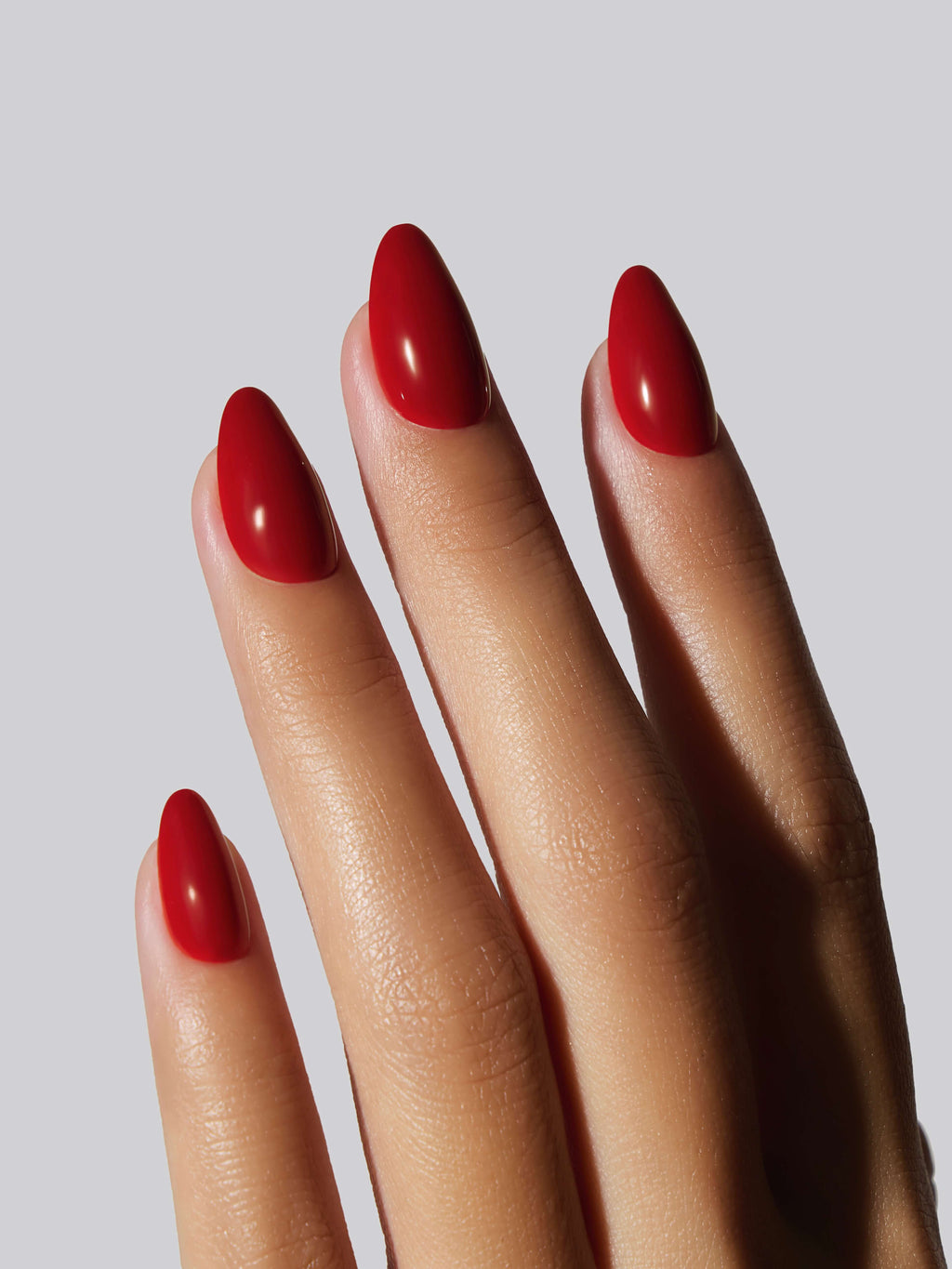 Short Red Nails with Almond Geometry